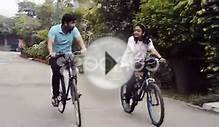 clip 49857436: Tracking shot of a young couple riding bicycle