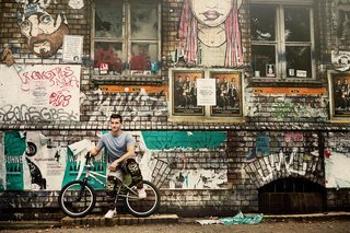 American BMX freestyle rider Tim Knoll stands along with his BMX cycle in Berlin, Germany on July 16, 2015