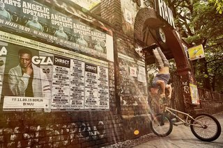 United states BMX driver Tim Knoll headstands on their bicycle in Berlin, Germany on July 15, 2015