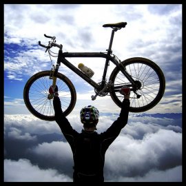 Man supporting a x-country mountain cycle